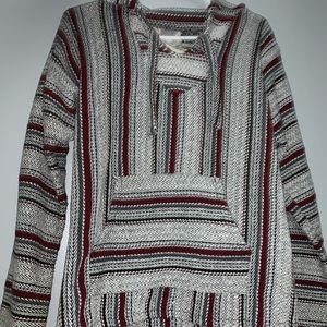 Grey, green, red, and black drug rug